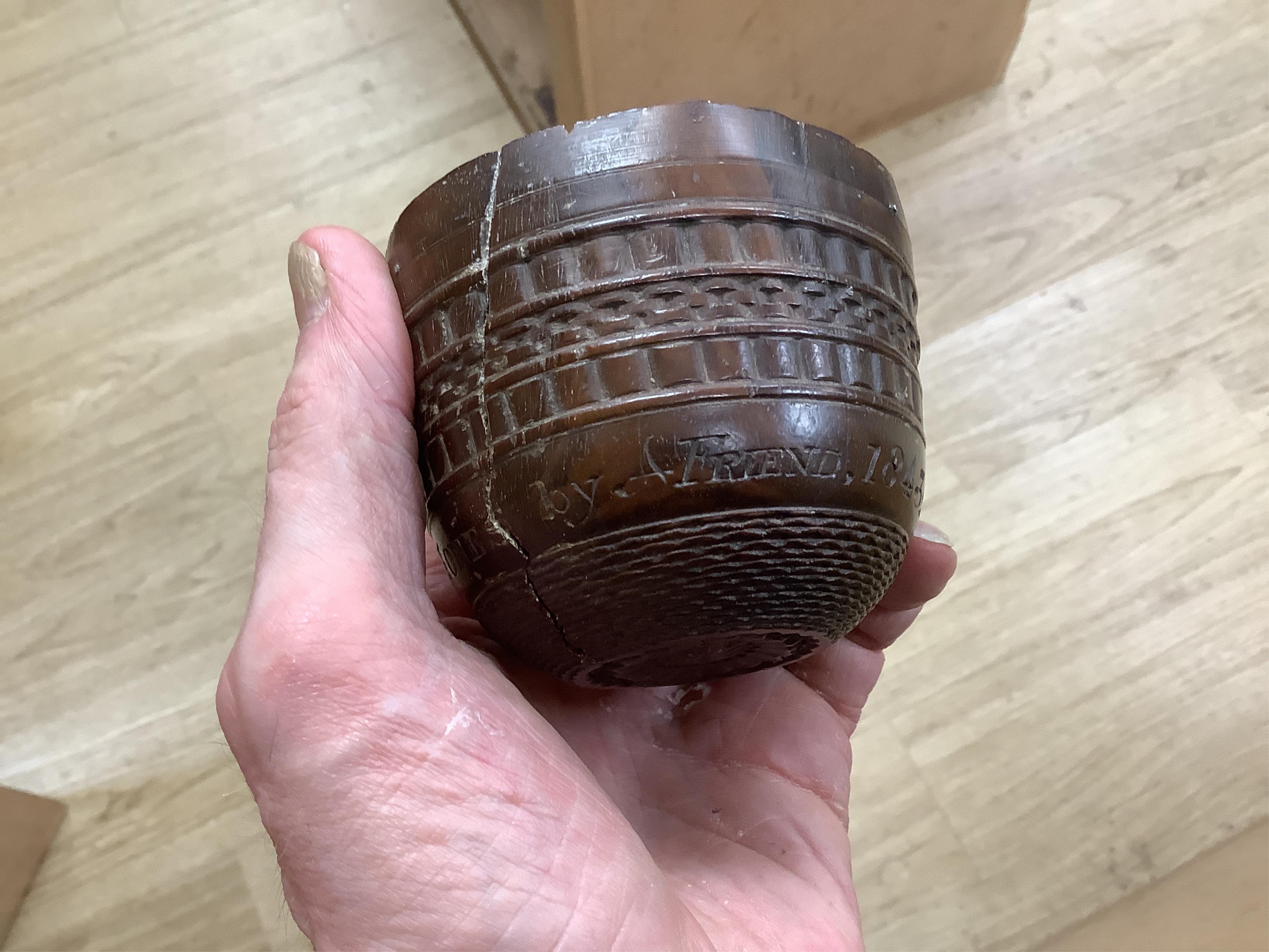 A 19th century or earlier engine-turned lignum vitae tumbler cup, engraved ‘Presented to M. S. Jones by a Friend 1843 AD 1701 +’, 6.5cm high, by repute found on the roof plate of Kenwood house London in 2012, during reno
